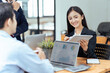 © itchaznong - Business woman present strategy plan on tablet to corporate colleagues in the office