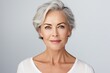 © Stavros - Grey haired middle aged woman. Women's health care concept. Luxurious middle-aged woman with a short gray hair looking at camera.