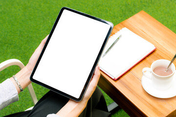 Poster - Blank screen tablet white background in woman hand for advertising text and copy space. Working from anywhere concept.
