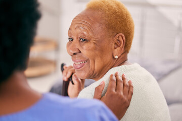 Canvas Print - Smile, talking and a senior woman with a caregiver for medical attention, care and support in a home. Happy, love and an elderly patient with healthcare, communication or service from a nurse