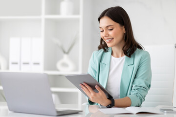 Wall Mural - Happy millennial european business lady, manager, ceo use laptop to chat and tablet