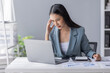 © David - Portrait of tired young business Asian woman work with documents tax laptop computer in office. Sad, unhappy, Worried, Depression, or employee life stress concept