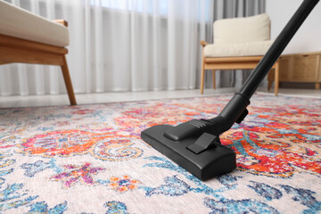 Canvas Print - Dry cleaner's employee hoovering carpet with vacuum cleaner indoors, space for text