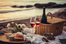 Romantic Picnic At Sea Beach With A Pink Glass Of Wine On Background