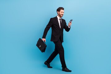 Sticker - Full body length photo of executive director young man hold smartphone chatting walking with diplomat isolated on blue color background