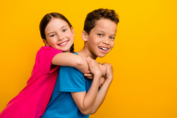 Sticker - Photo of adorable cute preteen schoolchildren wear t-shirts having fun together empty space isolated yellow color background