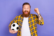 © deagreez - Photo of overjoyed man wear checkered trendy clothes hold ball raise hand fist celebrate victory isolated on purple color background