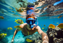 Man Snorkeling In The Tropical Water With Colorful Fishes And Corals. Shallow Field Of View