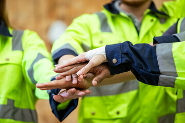 Wall Mural - Team engineering and foreman connect join hands successful projects, Stack of hands, Teamwork partner concept. warehouse diversity worker handshake agreement.