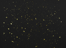 Gold Flakes Of Potal On Black Textured Paper