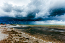 Storm Clouds Over The Sea. Coast Landscape In Germany. Baltic Sea With Dramatic Sky And Birds, Terns