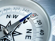 © tete_escape - Business goals direction, guidance, mission plan, navigate strategy, achievement objectives and success concepts. Close-up target dart icon on modern round white compass with metalic silver arrow.