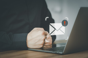 Poster - Male hand using a computer laptop with an email icon, Email alert with a caution warning sign for notification error. Security protection on the internet, junk mail, and compromised information.