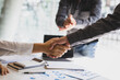 © Wasan - Business meeting, businessman shaking hands in business partnership meeting, business cooperation.