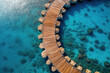 Aerial view of a wooden walkway in the turquoise ocean. Travel concept