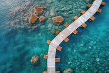 Aerial View Of A Wooden Over Water Bridge In The Turquoise Ocean On Tropical Island.