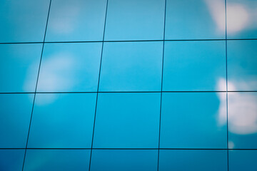 Wall Mural - architecture - city skyline skyscraper windows closeup with blue sky and clouds reflections