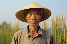 Portrait Of A Fictional Traditional Asian Rice Farmer Working In His Farm And Smiling. Generative AI.