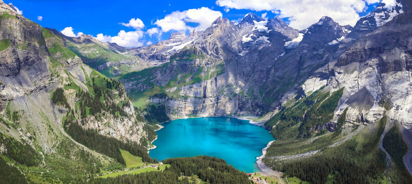 idyllic swiss mountain lake oeschinensee (oeschinen) with turquise water and snowy peaks of alps mou
