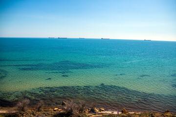 Wall Mural - Turquoise sea from a cliff with ships on the horizon	
