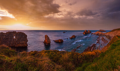 Canvas Print - Sunset Arnia Beach (Spain, Atlantic Ocean) coastline landscape.