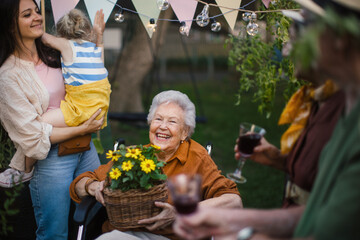 family haivng party during warm summer evening in urban garden