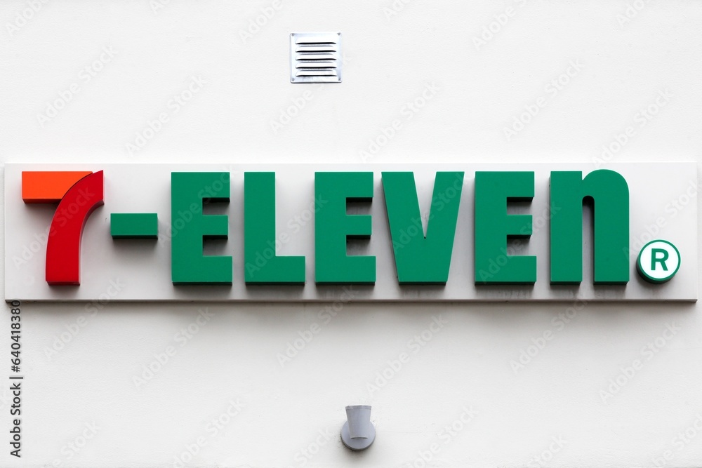 Aarhus, Denmark - August 6, 2023: 7-Eleven logo on a wall. 7-Eleven is an international chain of convenience stores that operates primarily as a franchise