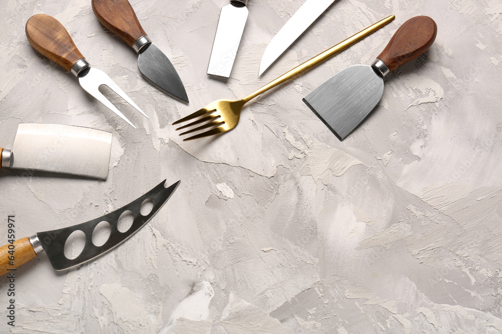 Different kitchen utensils on grey background