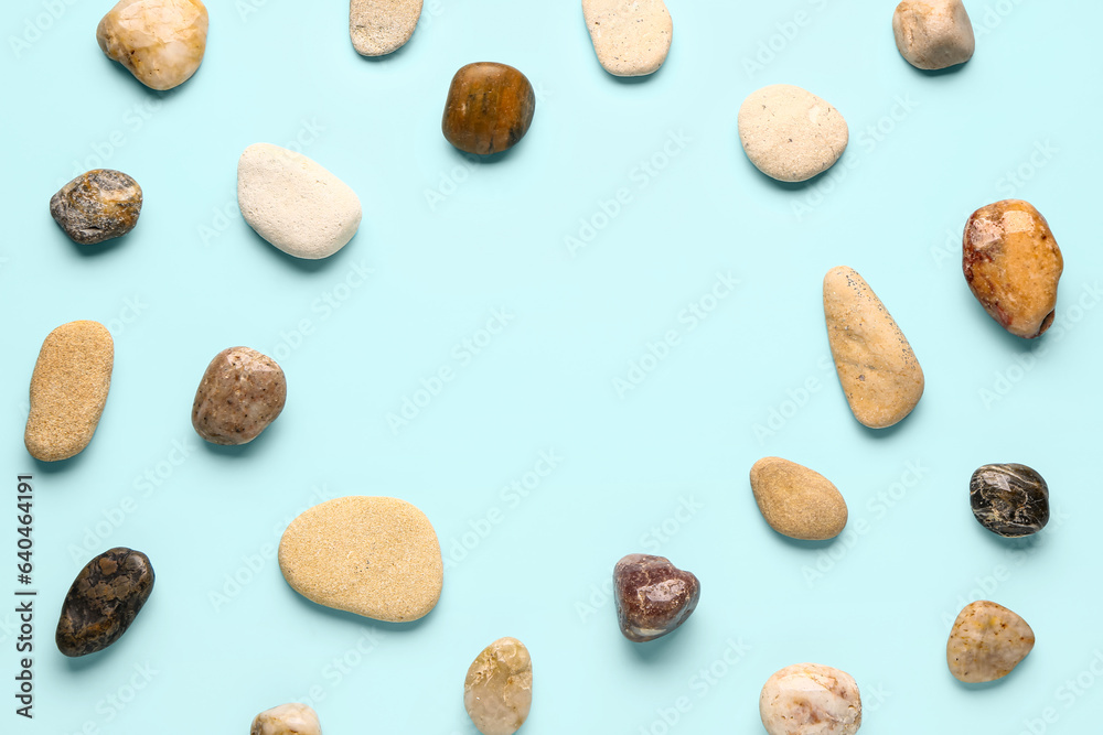 Frame made of pebble stones on blue background