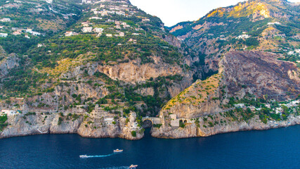 Wall Mural - The Amalfi Coast is a breathtaking stretch of coastline in southern Italy, known for its vertiginous cliffs adorned with colorful villages, turquoise waters, and lush terraced gardens. 