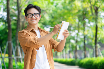 Wall Mural - Portrait of young Asian man outside