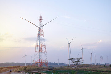 Wall Mural - windmill turbine farm for electricity generation on landscape mountain at sunset sky, green power in