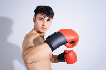 Canvas Print - Photo of young Asian boxer on white background