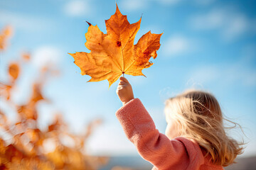 Wall Mural - Girl holding autumn maple leaf