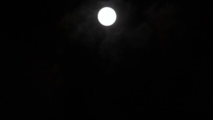 Wall Mural - timelapse of full moon rising vertically in dark black sky, moon lapse