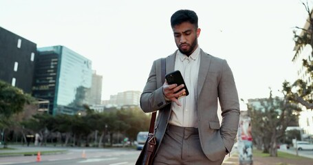 Aufkleber - Phone, walking and young businessman in the city scroll on social media, mobile app or the internet. Technology, professional and male lawyer browsing on cellphone for commuting in an urban town road