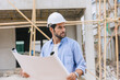 © Quality Stock Arts - Construction engineer builder work in construction site. Architect home project foreman chief designer working with floor plan.