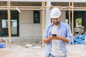 happy foreman builder using smart phone calling business contact in construction site. construction engineer or architect with modern connection technology device.real estate investor