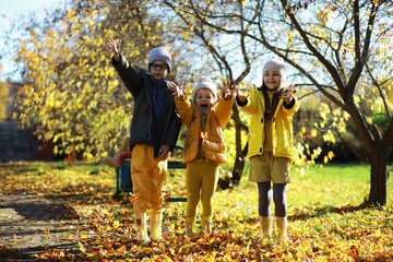 Children Having Fun And Balancing On Tree In Fall Woodland