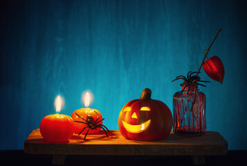 Wall Mural - halloween decorations with pumpkin on dark wooden background