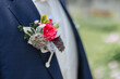 Groom wearing a boutonniere on his wedding day close-up