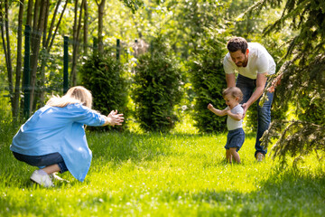 Cute young family spending time together in the park