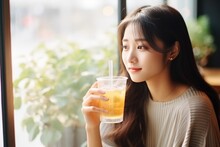 Surprise Asian Girl Eats Iced Tea In In A Cafe In Paris