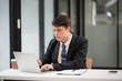 © aekachai - Businessman talking to customers online together at the office.