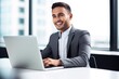 © stickerside - shot of a happy young businessman using his laptop in the office