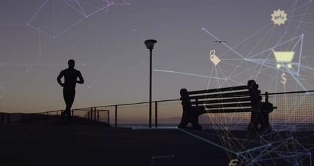 Wall Mural - Animation of connected icon globe over silhouette of african american man running at beach