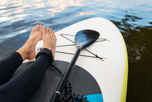 Active Woman On Surfboard, Closeup Of Water Surface, Legs And Board. Outdoor Activity.