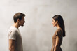 Man and woman stand facing each other, sense of confrontation an