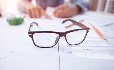 glasses on a construction drawing in the office, close-up