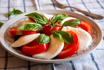 Canvas Print - Caprese salad with mozzarella cheese and tomatoes of Italian cuisine